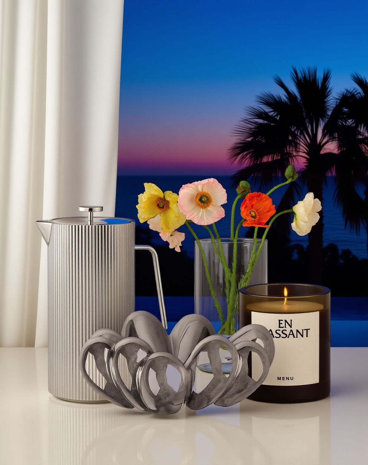 a table with a candle, vase, and flowers on it