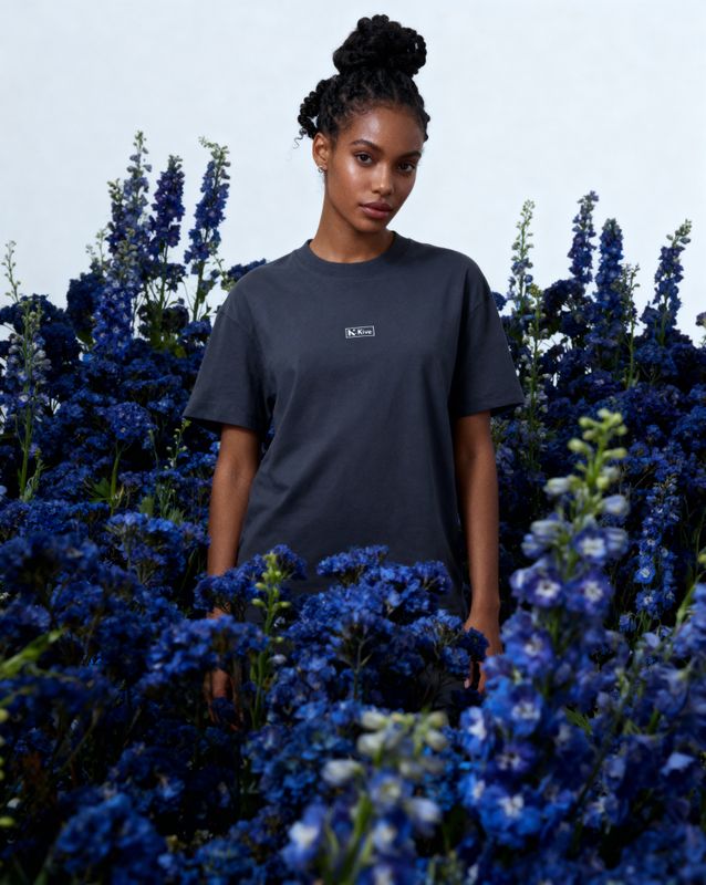 a woman standing in a field of blue flowers