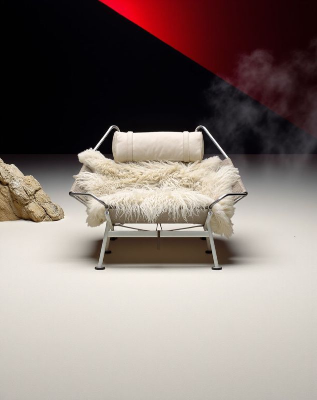 a white chair sitting next to a rock formation