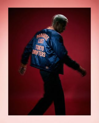 a man in a blue jacket is walking