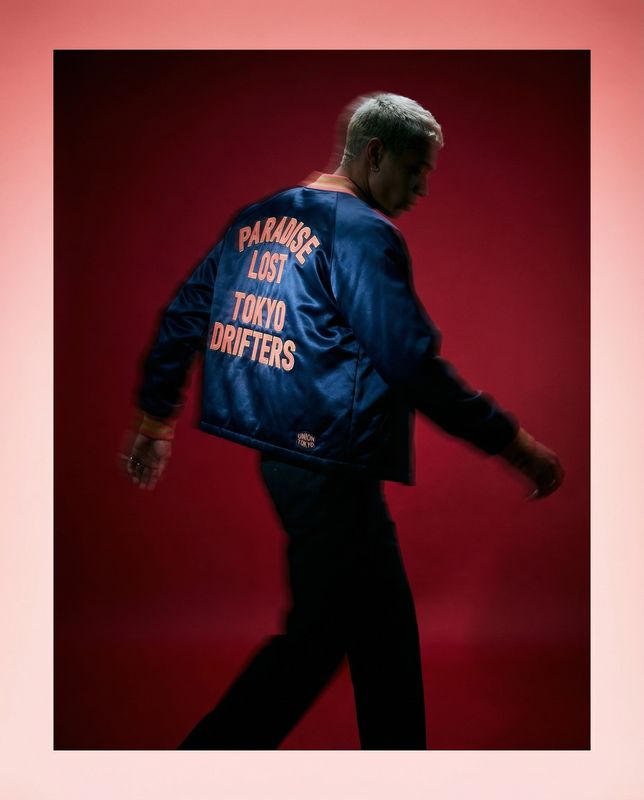 a man in a blue jacket is walking