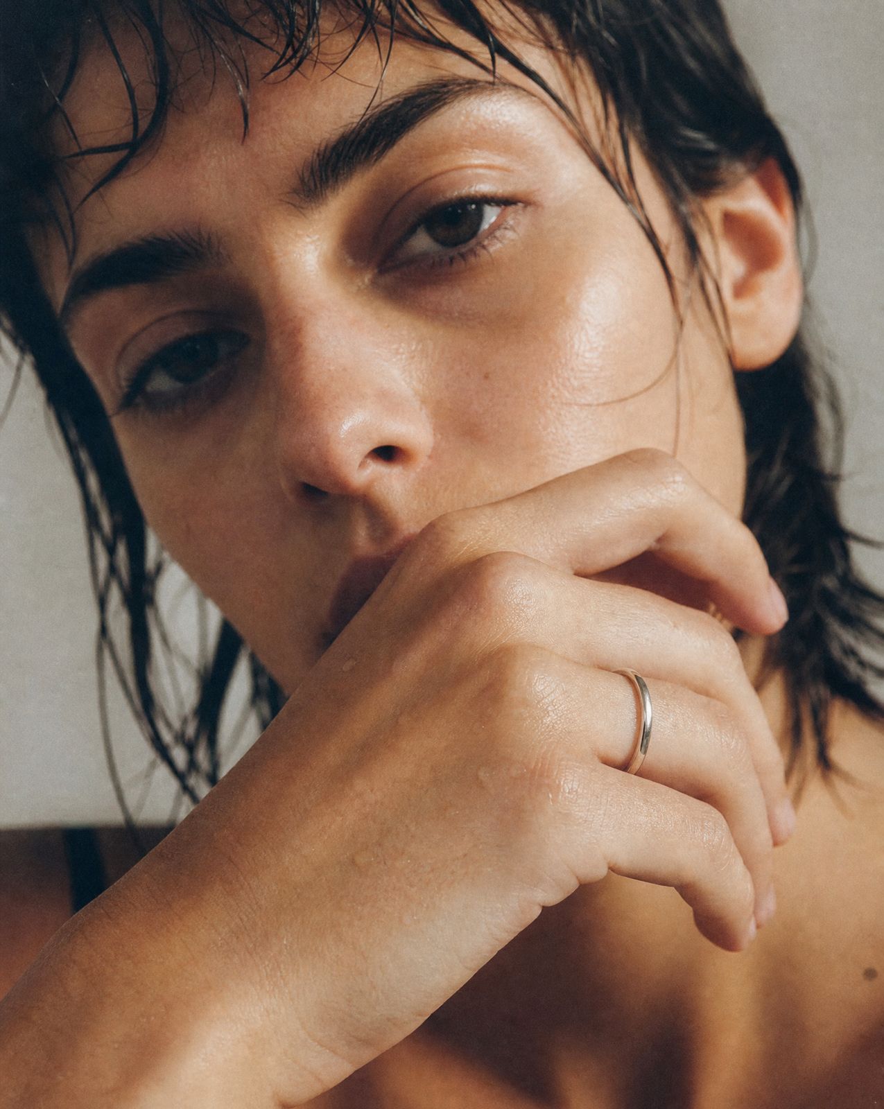 a shirtless man with a ring on his finger