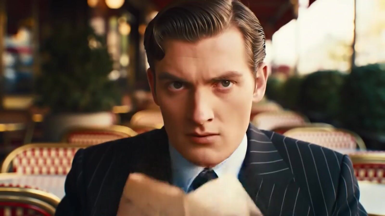 a man in a suit and tie sitting at a table