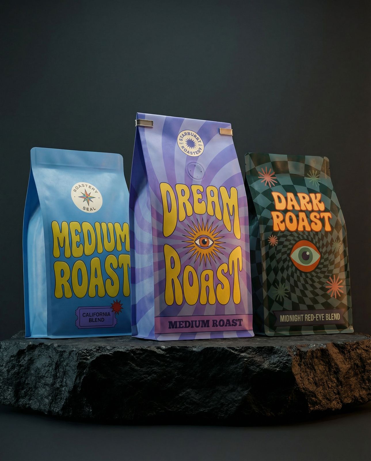 three bags of coffee sitting on top of a rock