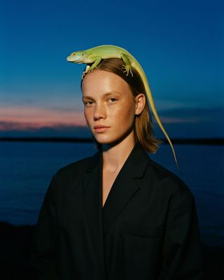 a woman with a lizard on her head