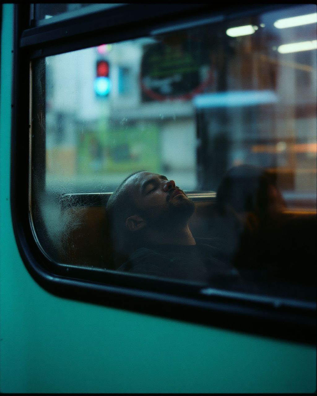 a man is looking out the window of a bus