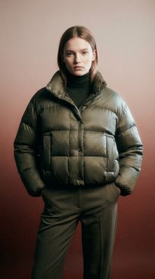 a woman wearing a green jacket and pants