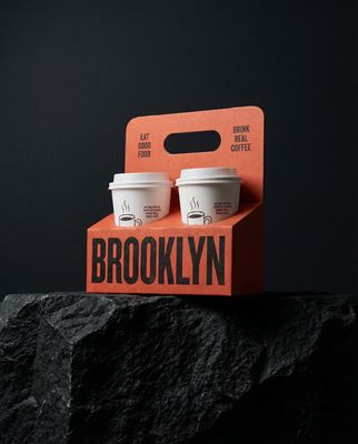 two cups of coffee sitting on top of a rock