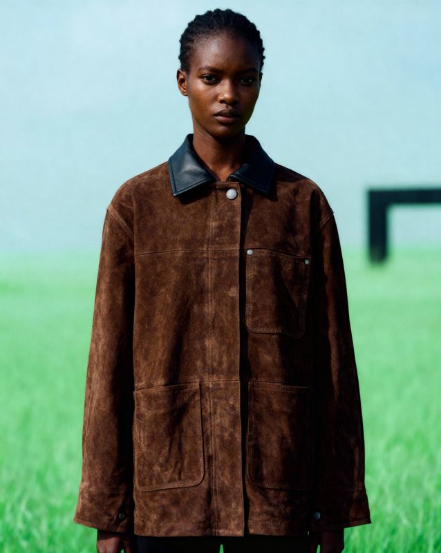 a woman standing in a field of green grass