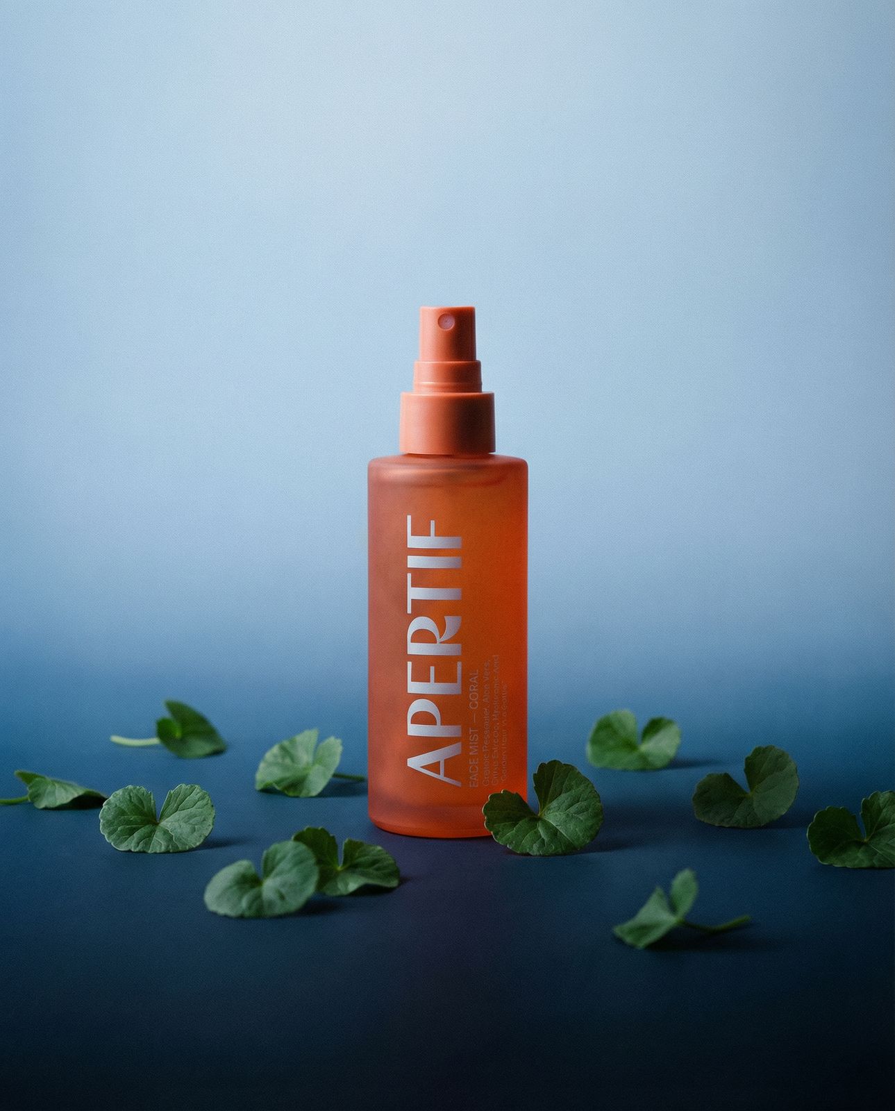 a bottle of argan oil on a blue background