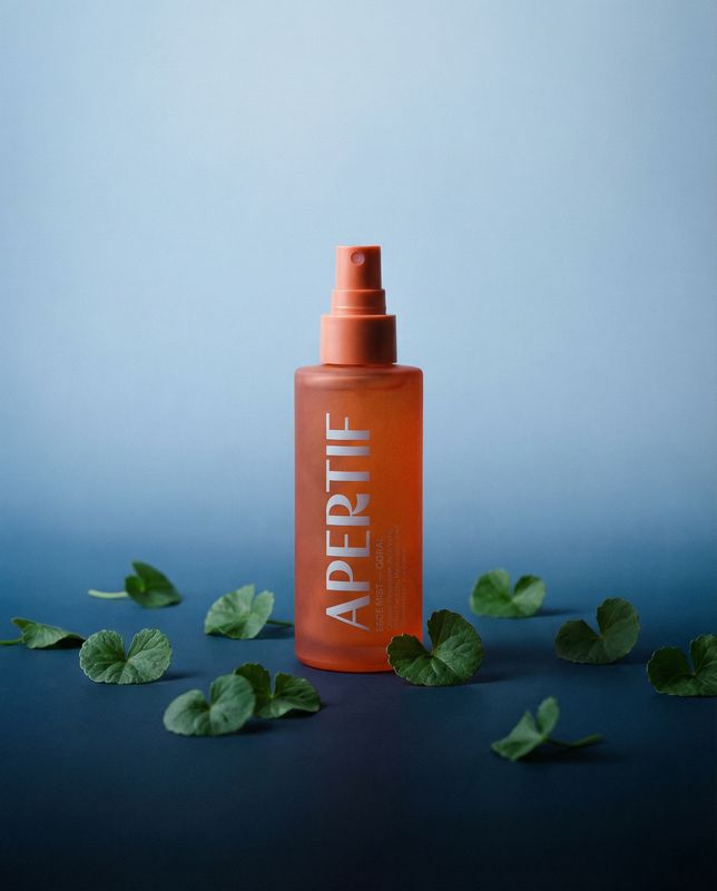 a bottle of argan oil on a blue background