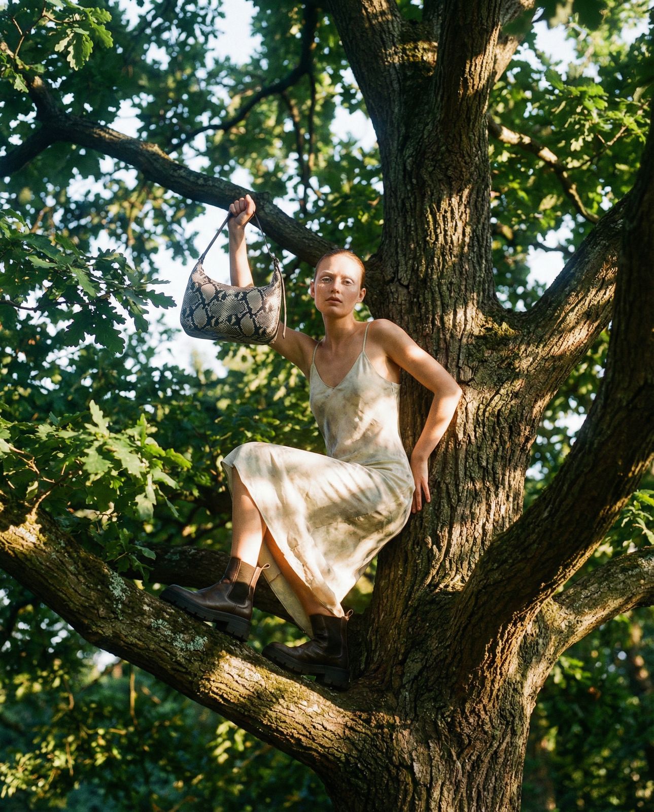 a woman in a white dress climbing a tree