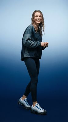 a woman with long hair and blue shoes