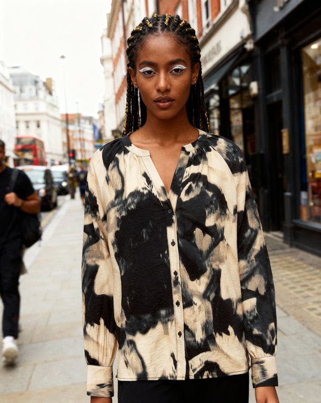 a woman standing on a sidewalk in front of a store