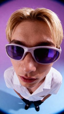 a man wearing sunglasses and a bow tie