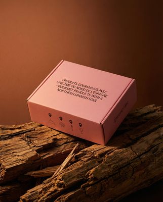 a pink box sitting on top of a piece of wood