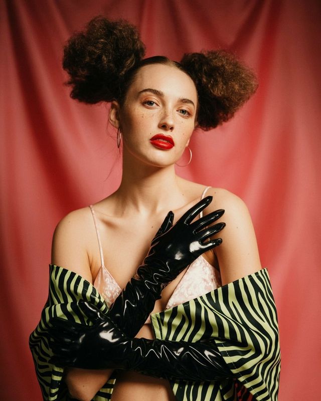 a woman wearing gloves and a bra top