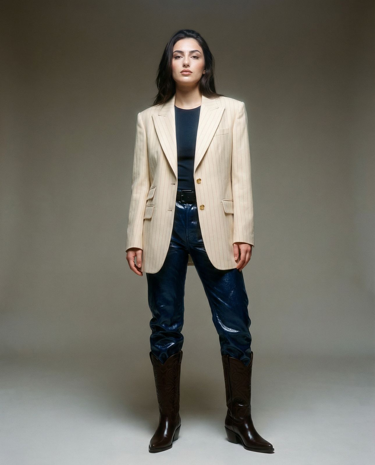 a woman in a white jacket and jeans