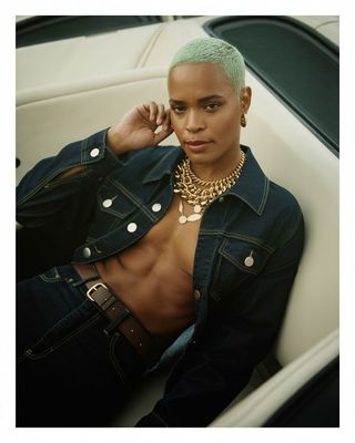 a woman with green hair sitting in a car