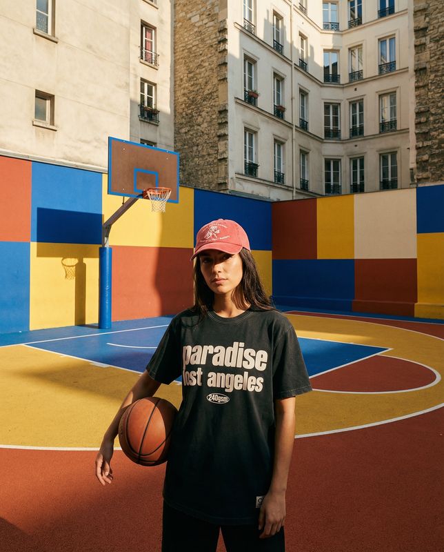 a woman standing in front of a basketball court