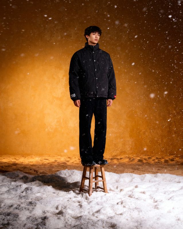 a man standing on a stool in the snow
