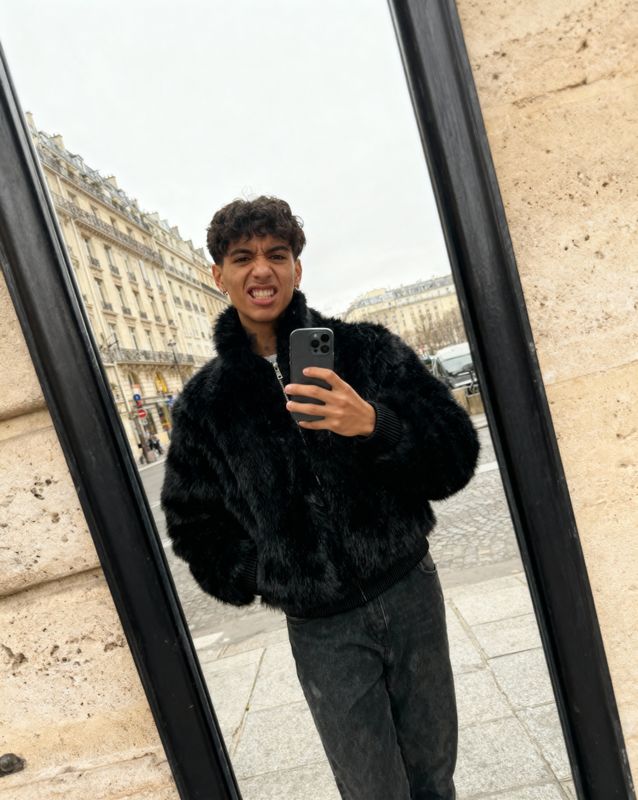 a man taking a selfie in front of a mirror