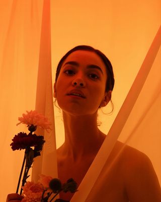 a woman holding a bouquet of flowers in front of her face