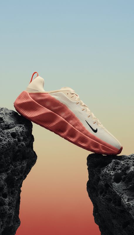 a pair of nike sneakers sitting on top of a cliff