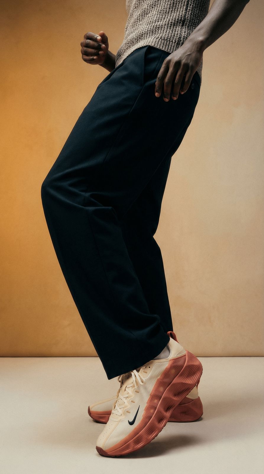 a man standing on top of a pair of shoes