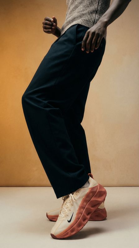 a man standing on top of a pair of shoes