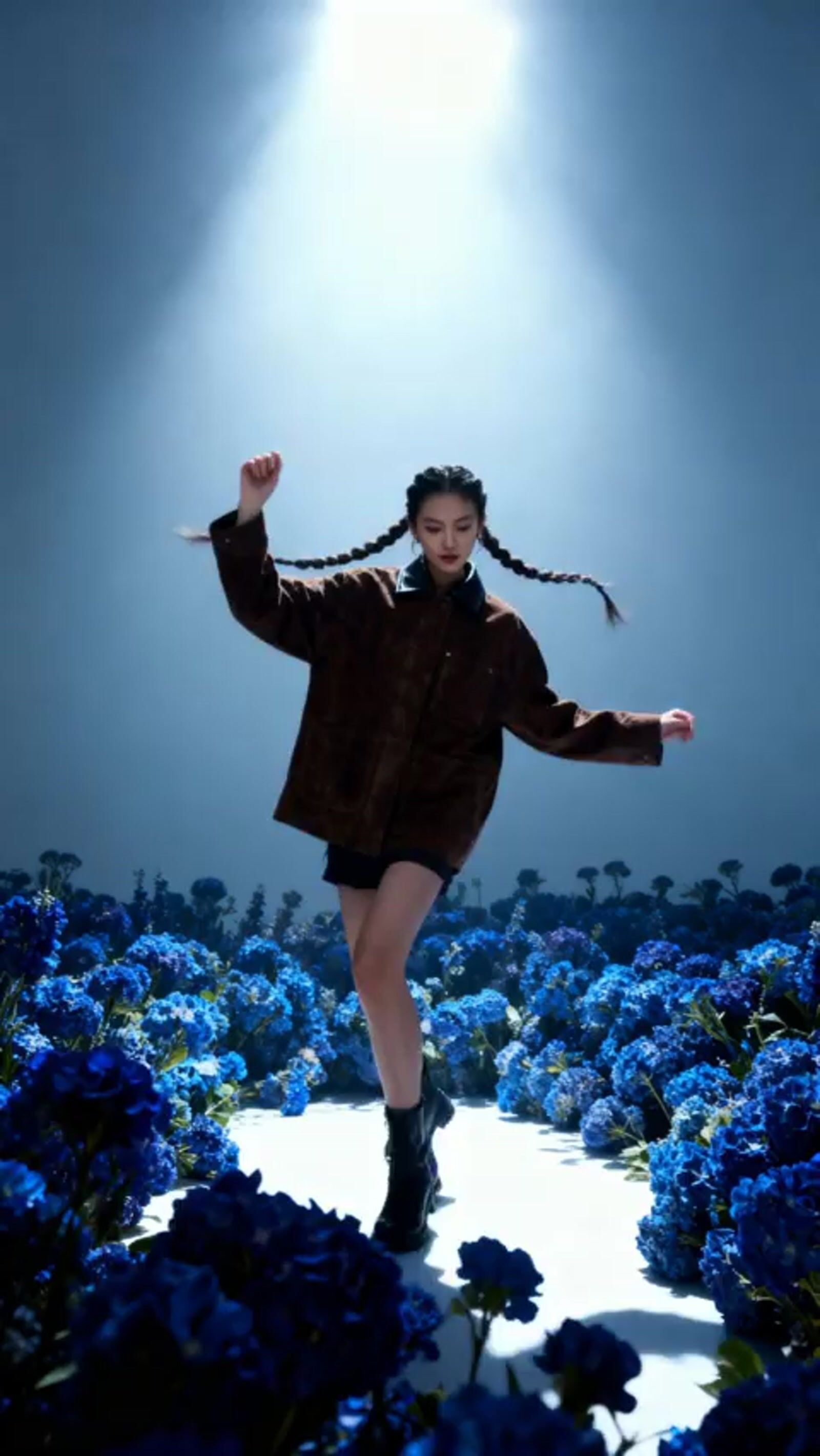 a woman in a field of blue flowers