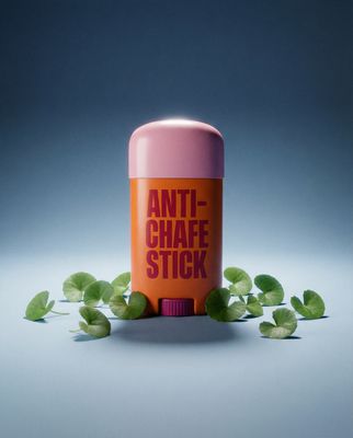 a can of anti - chafe stick surrounded by leaves