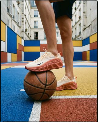 a person standing on top of a basketball on a court