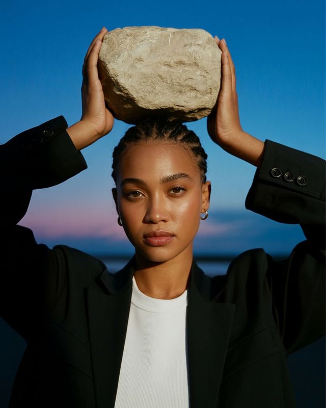 a woman holding a rock over her head