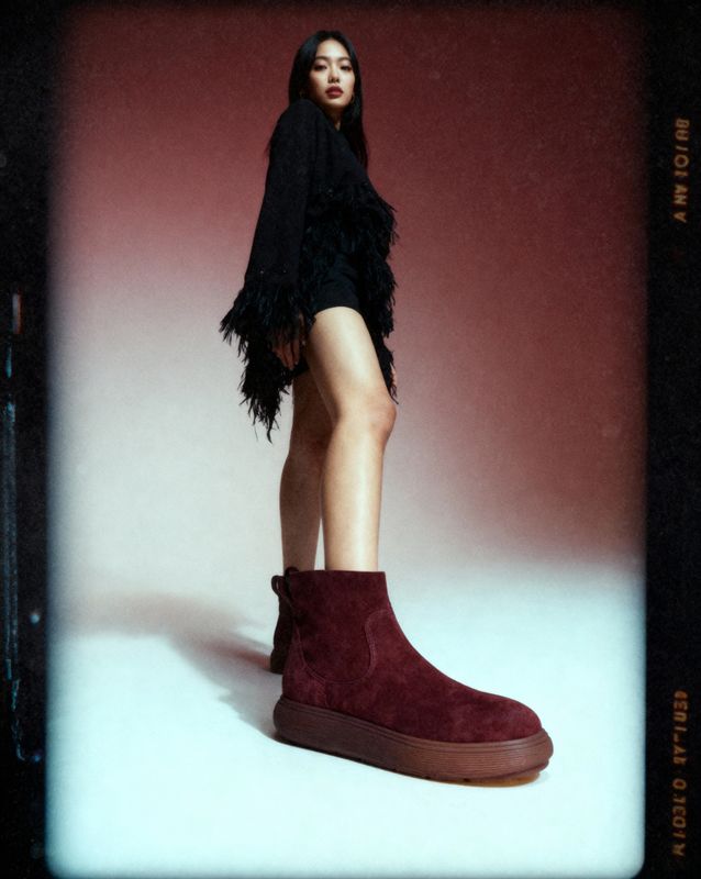 a woman in a short skirt and boots