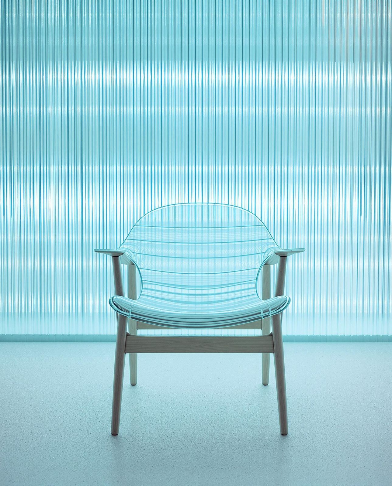 a blue chair sitting in front of a window