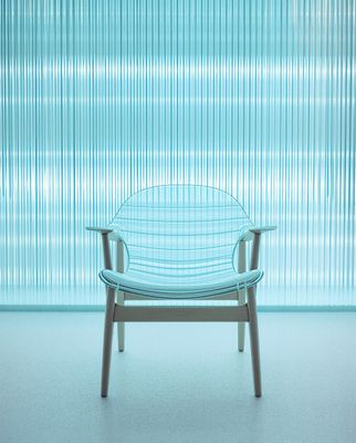 a blue chair sitting in front of a window