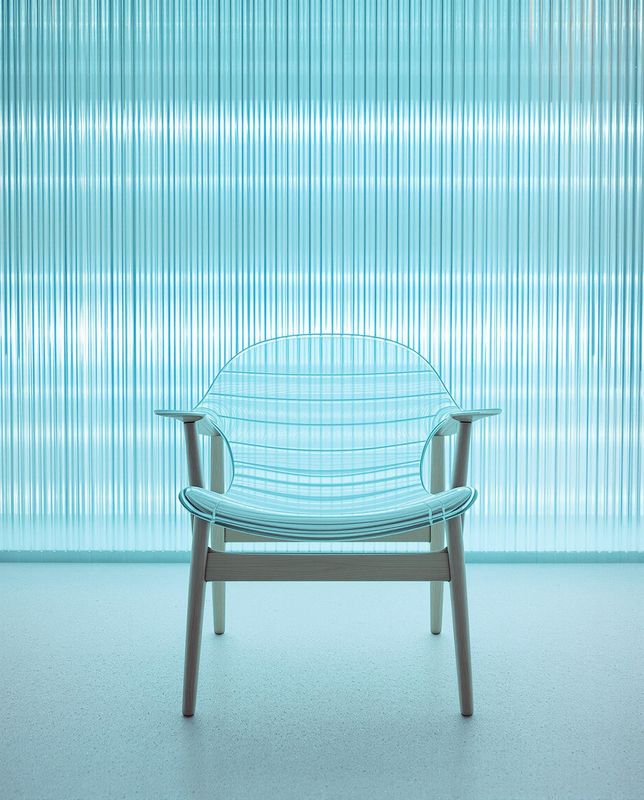 a blue chair sitting in front of a window