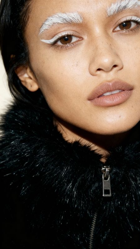 a close up of a person wearing a fur coat