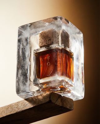 a bottle of whiskey sitting on top of an ice block