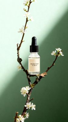 a bottle of perfume sitting on top of a tree branch