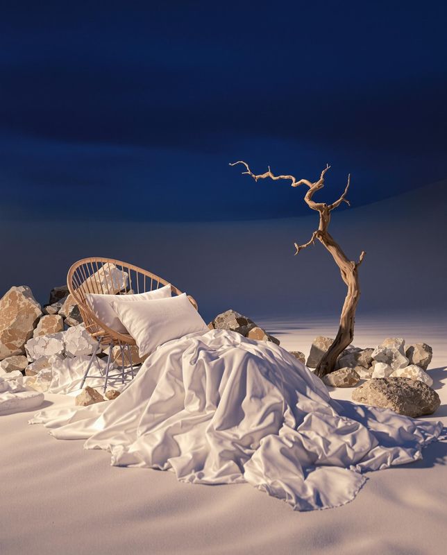 a chair sitting on top of a pile of snow next to a tree