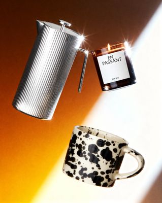a coffee cup and a teapot on a table