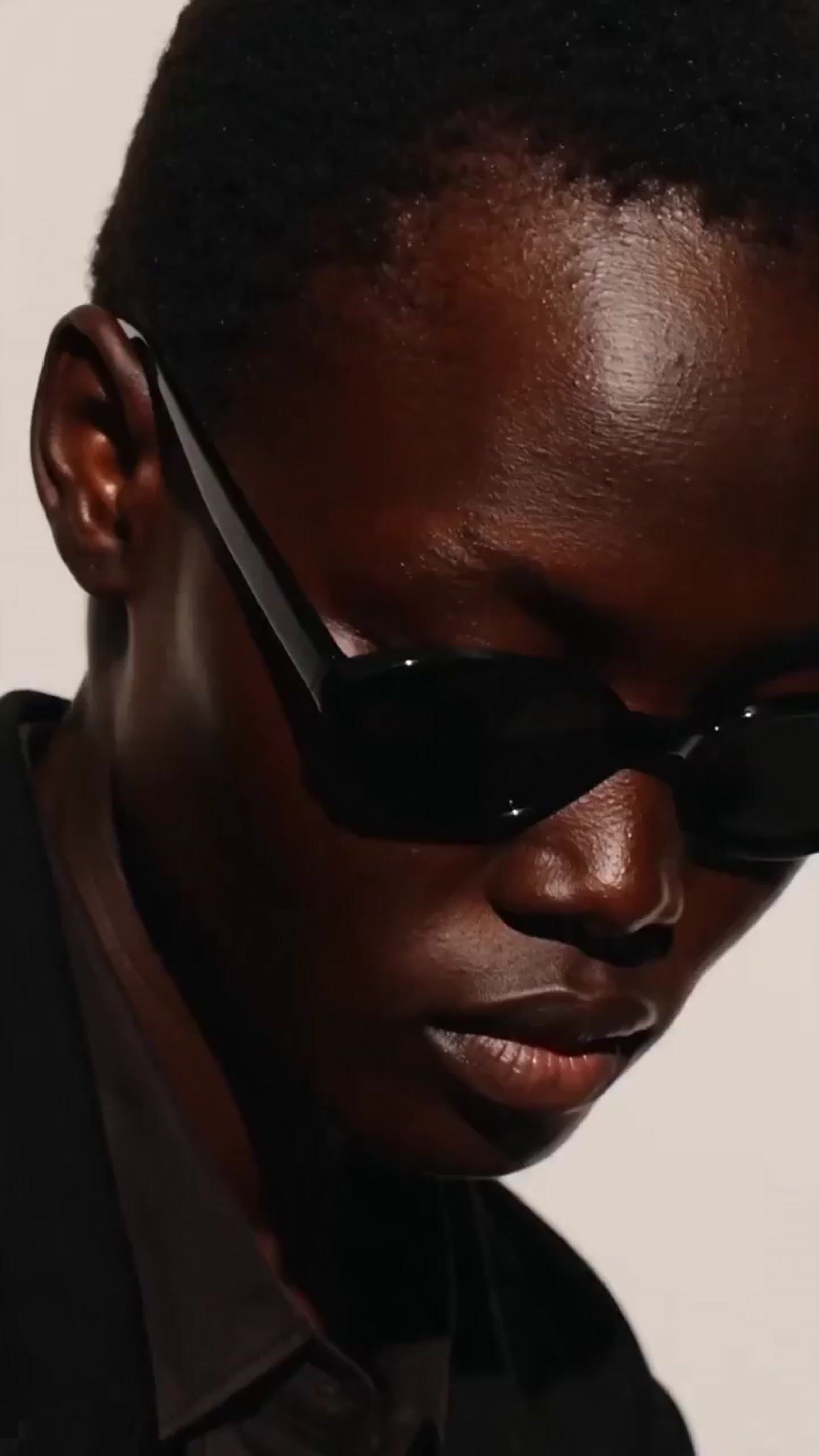 a man wearing sunglasses and a black shirt