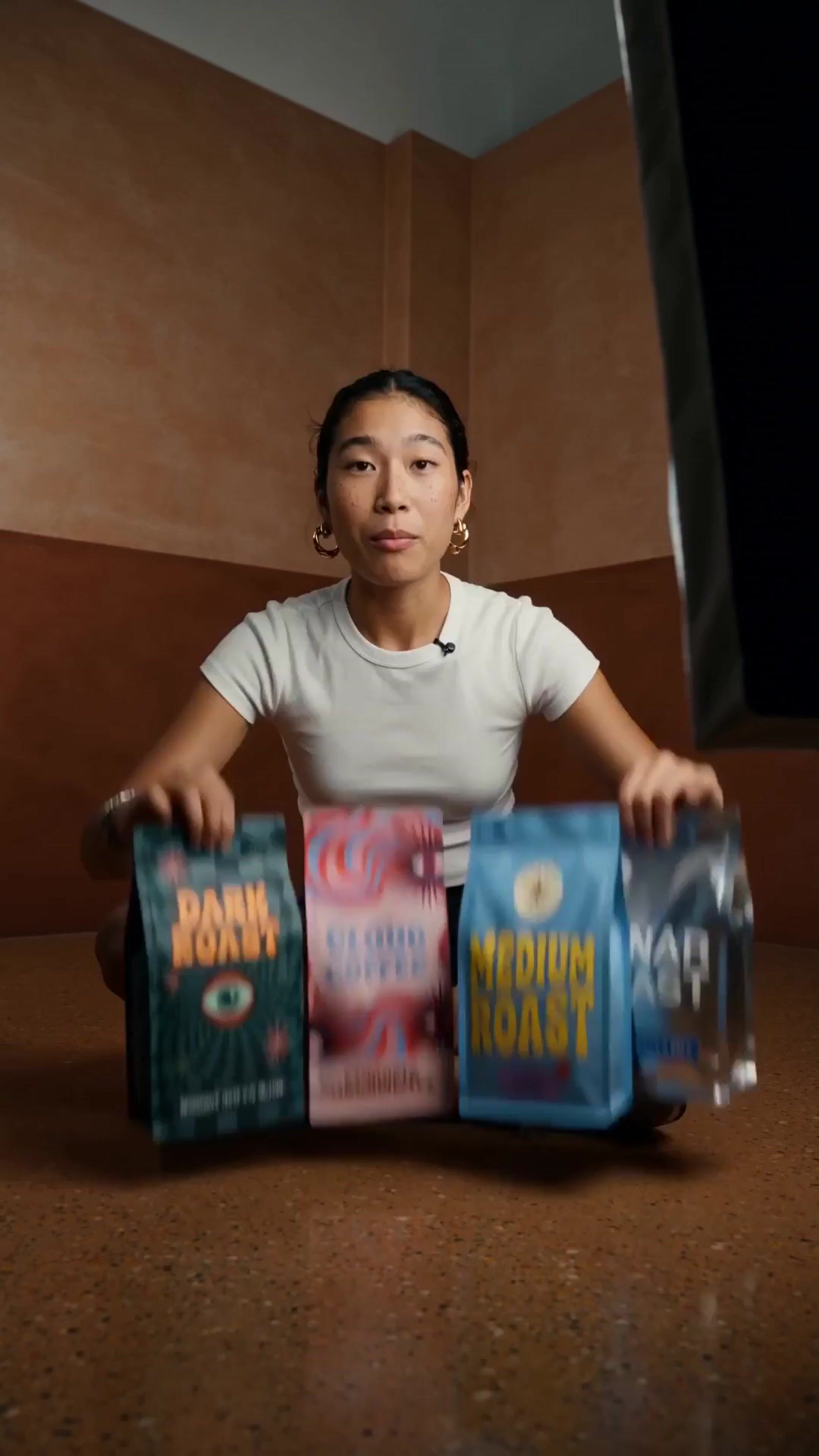 a woman sitting on the floor holding three bags of food