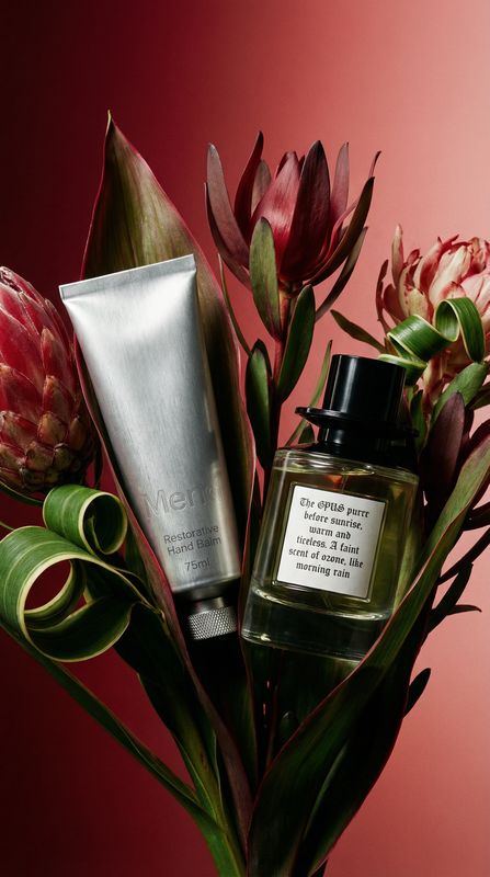 a vase filled with flowers next to a tube of cream