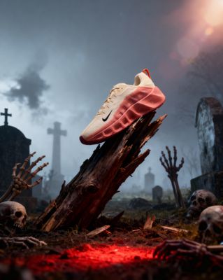 a pair of sneakers sitting on top of a tree stump