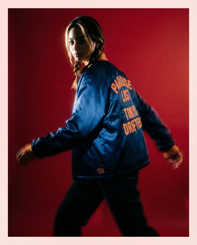 a woman in a blue jacket is walking