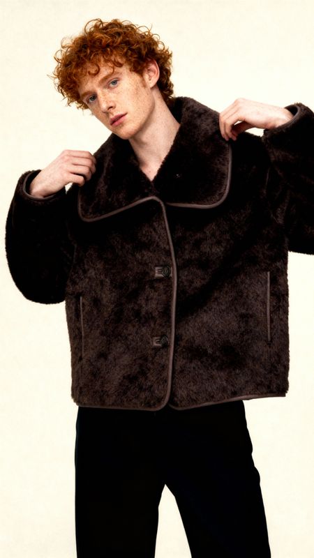 a man with red hair wearing a black jacket