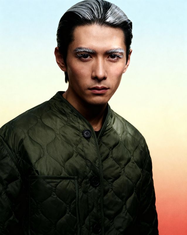 a man in a green jacket with a weird look on his face